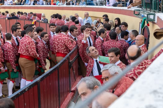 March 26, 2023 Lisbon, Portugal: Tourada - bullfighters in costumes go out of arena to amphitheater sits. Mid shot