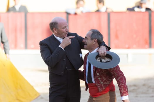 March 26, 2023 Lisbon, Portugal: Tourada - elderly forcado and cavaleiro on the arena. Mid shot