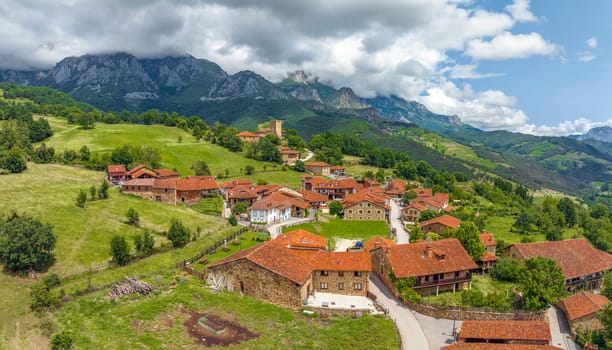 Mogrovejo village overlooking Peaks of Europe mountains with wooden balcony, Cantabria,Spain. named beautiful town of Spain