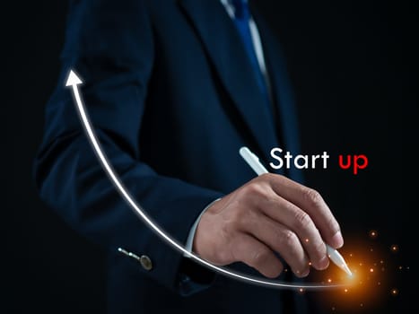 Businessman presses the pen at the starting point to start a business. Startup concept. Business concept.