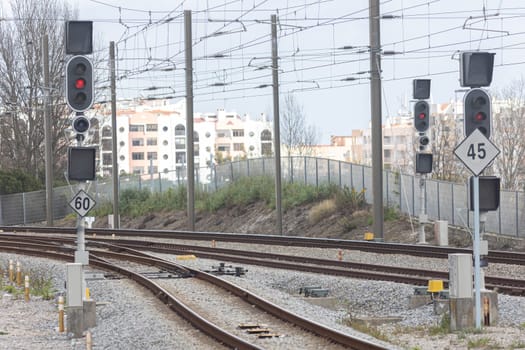 Railway tracks and traffic lights controlling traffic. Mid shot