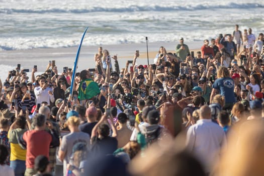 14 march 2023 Peniche, Portugal: lots of people on the beach at surf competition - congratulations to the winner. Mid shot