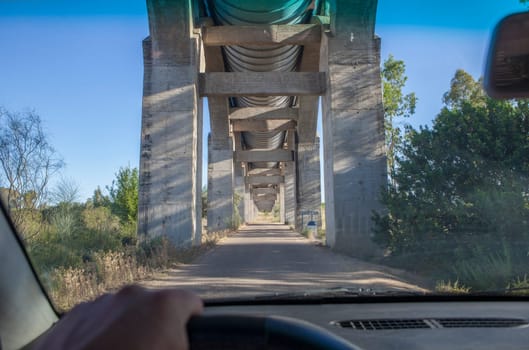 Driving under Acedera Aqueduct. Orellana Irrigation canal, Vegas Altas del Guadiana, Extremadura, Spain
