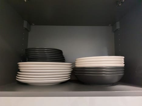 Top kitchen cupboard showing dishware. Handleless cupboards concept