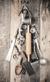 Chistmas tree shape of vintage kitchen and baking utensils on a rustic wooden kitchen table, Christmas bakery concept