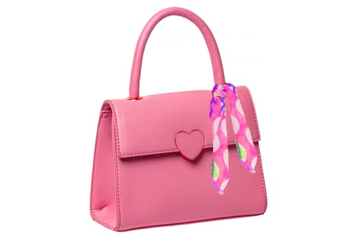 Stylish women's handbag. A fashionable female pink luxury handbag decorated with colorful cloth tape isolated on white. Fashionable womans accessories. Advertising.