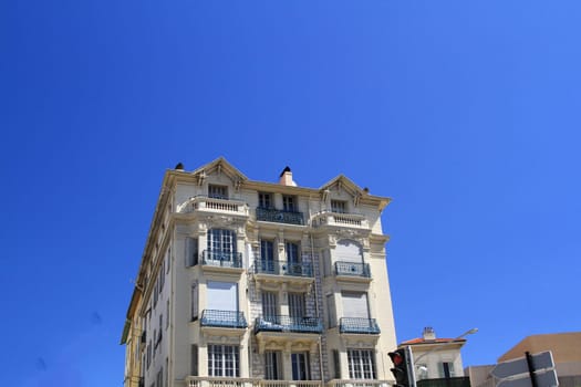 Beautiful architectural building in Nice, France against a blue sky