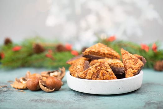 Nut corner triangles, traditional german sweets called Nussecke, covered with chocolate, christmas cake
