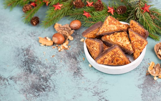 Nut corner triangles, traditional german sweets called Nussecke, covered with chocolate, christmas cake