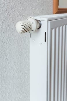 Detail of turned off thermostat, temperature knob of heating radiator. Saving energy and warm home concept, living costs.