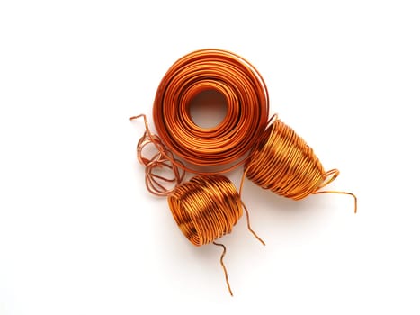 Coiled copper wires on a white background, precious metal recycling concept, recycling and resource conservation
