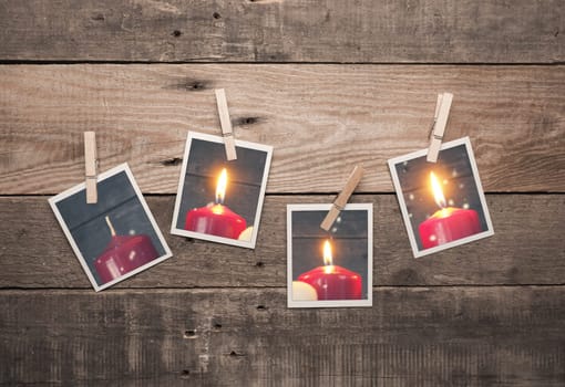 Four old photo frames with Advent candles on a rustic wooden wall, third Advent concept