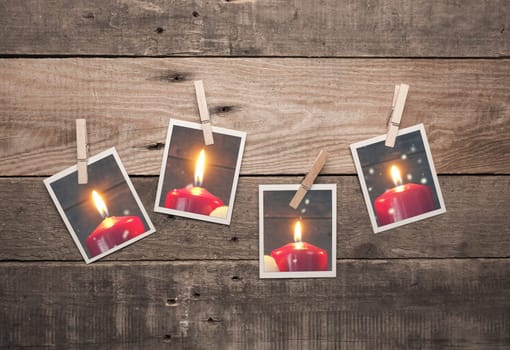 Four old photo frames with Advent candles on a rustic wooden wall, fourth Advent concept