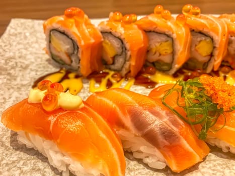 Sashimi sushi in the plate on the wood table. Sushi is a type of food preparation originating in Japan.