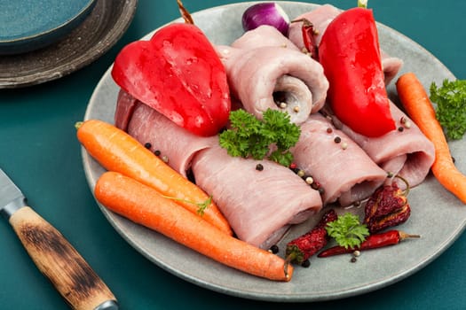 Fresh, uncooked pork meat rolls. Raw meat. Roll ready for baking.