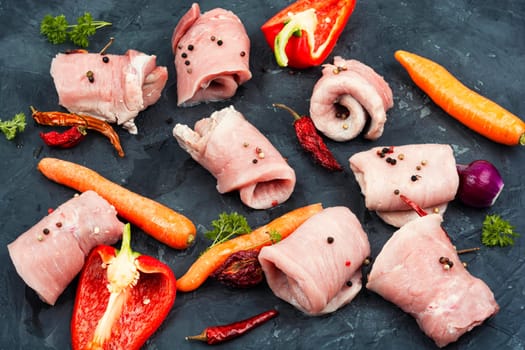 Fresh, uncooked pork meat rolls. Raw meat. Roll ready for baking.
