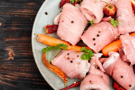 Fresh, uncooked pork meat rolls. Raw meat. Roll ready for baking.