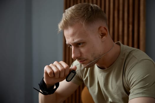 Closeup face portrait of emotional military man feeling stress and depression. Ptsd symptom