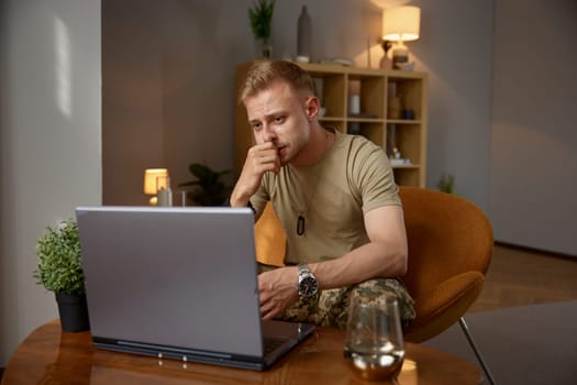 Online consultation of military man with psychiatrist. Soldier discussing injury and trauma with counselor during videocall chat appointment
