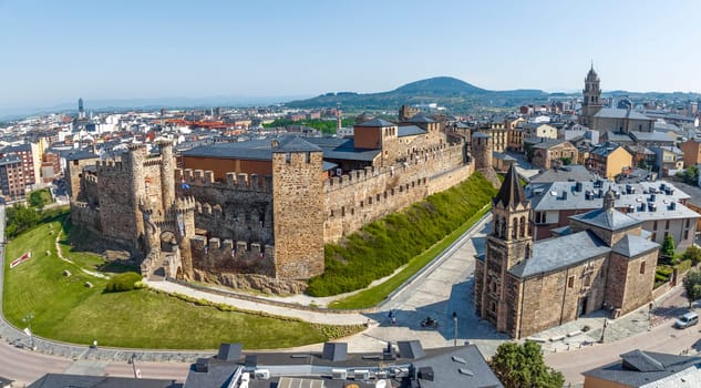 Templar castle in Ponferrada, Leon Spain medieval stone walls, towers, flags. Iglesia de San Andres