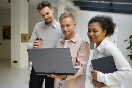 Friendly male colleague explaining how easy correct mistake to happy woman coworker. Pleasant conversation with help and support at workplace during coffee break