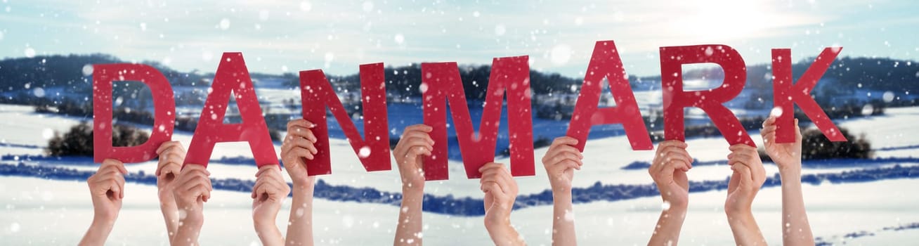 People Or Persons Hands Building Danish Word Danmark Means Denmark. White Winter Background With Snowflakes And Snowy Landscape.