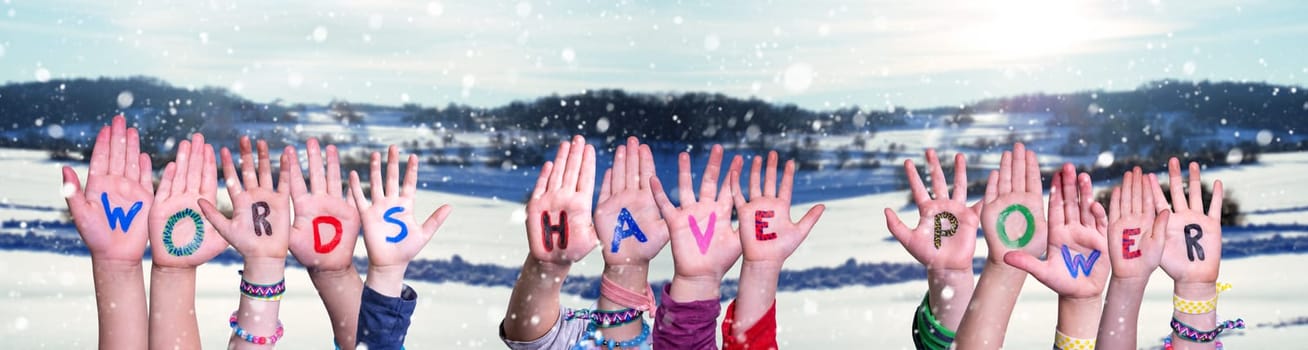 Children Hands Building Colorful English Word Words Have Power. White Snowy Winter Scenery And Landscape With Snowflakes As Background.