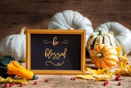 Autumn Pumpkin Decoration With English Text Be Blessed. Wooden Background with Corlorful Rustic Fall Decor Like Leaf And Golden Picture Frame