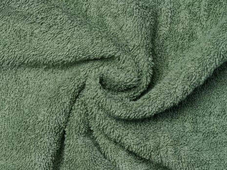 Texture of a green terry cotton towel, canvas. Macro