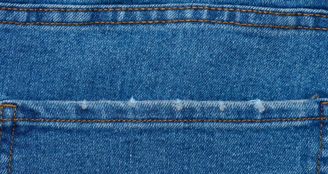 Fragment of the back pocket of blue jeans