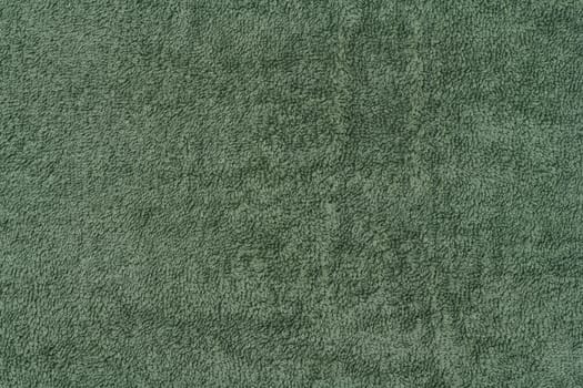 Texture of a green terry cotton towel, canvas. Macro