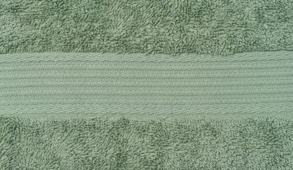 Texture of a green terry cotton towel, canvas. Macro