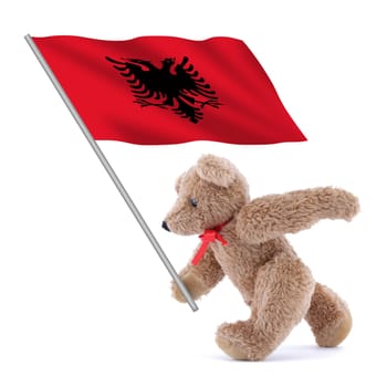 An Albania flag being carried by a cute teddy bear