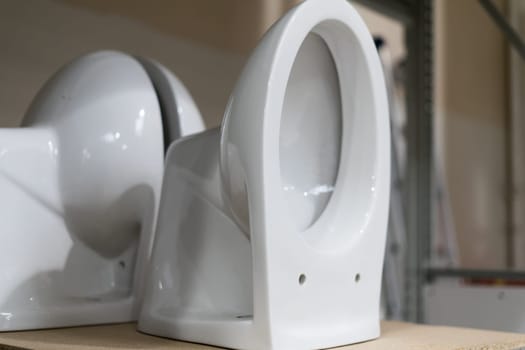 Showcase with toilets. Sale in a plumbing store of toilet bowls of different models.