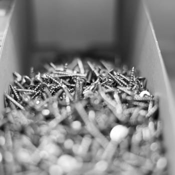 Silver grey self-tapping screws as an industrial background. Close up.