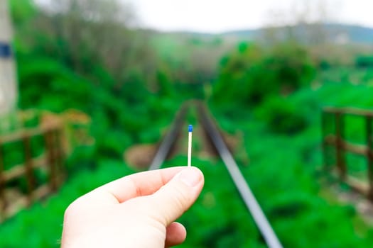 Matches on a rails railroad tracks background, fire on railways concept