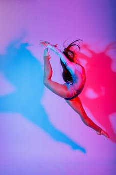 High jump, flight. Flexible girl, rhythmic gymnastics artist jumping. Grace motion action