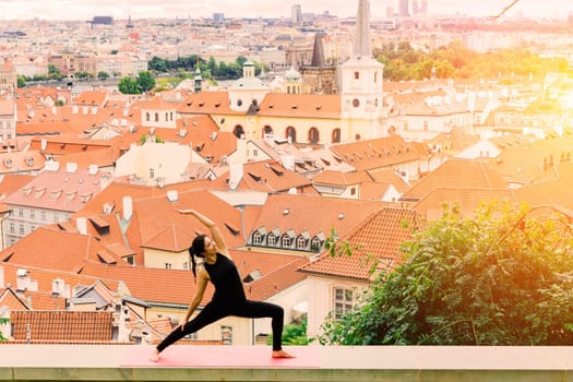 Healthy woman in a sportswear practicing yoga outdoor, doing exercise, full length portrait.
