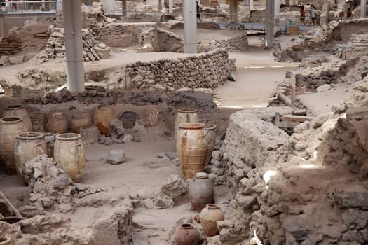 Santorini, Greece - July 01, 2021: Recovered ancient pottery in prehistoric town of Akrotiri, excavation site of a Minoan Bronze Age settlement on the Greek island of Santorini