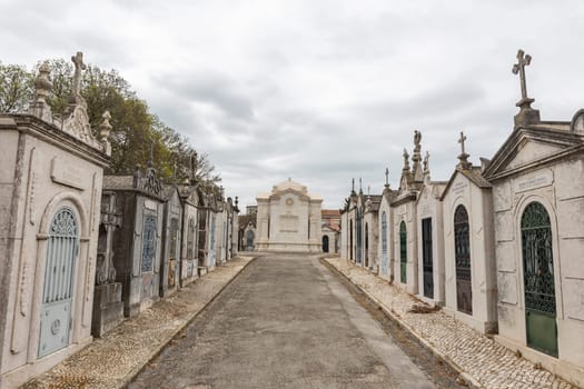 February 22, 2023 Lisbon, Portugal: Alto de Sao Joao Cemetery - the path between the family crypts leading to the mausoleum. Mid shot