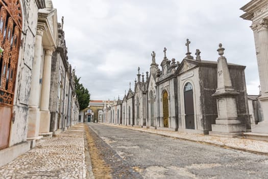 February 22, 2023 Lisbon, Portugal: Alto de Sao Joao Cemetery - the path in the cemetery surrounded by crypts. Mid shot