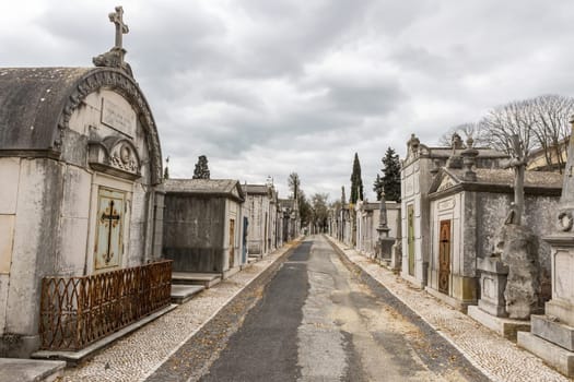 February 22, 2023 Lisbon, Portugal: Alto de Sao Joao Cemetery - the path between the crypts. Mid shot