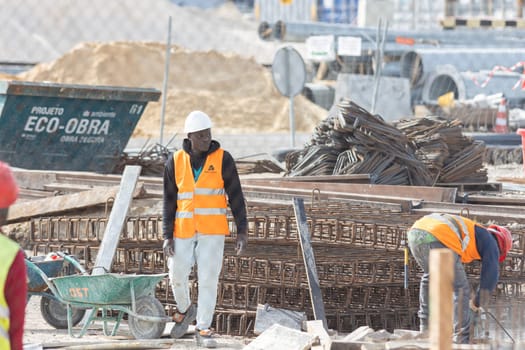 February 21, 2023 Lisbon, Portugal: black man worker works in the seaport. Mid shot