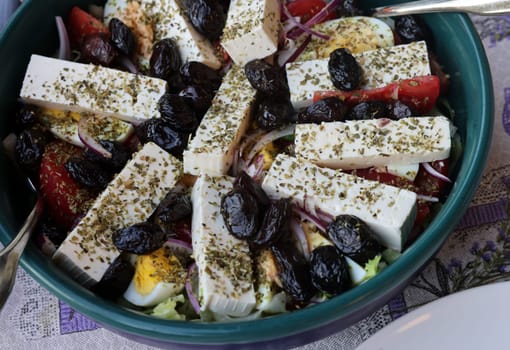 Greek salad with feta cheese and black olives. Typical delicious greek style lunch