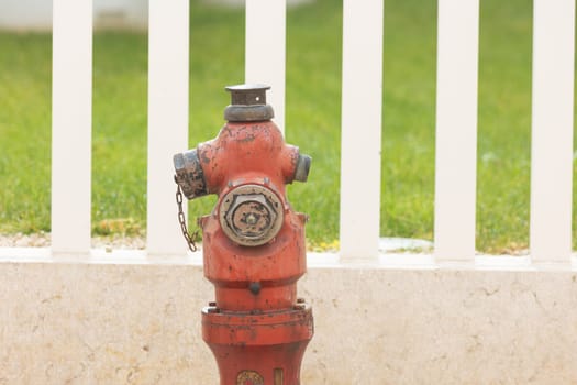Red fire hydrant on a clean road. Mid shot