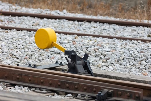 Yellow switch of railway tracks in day lighting. Mid shot