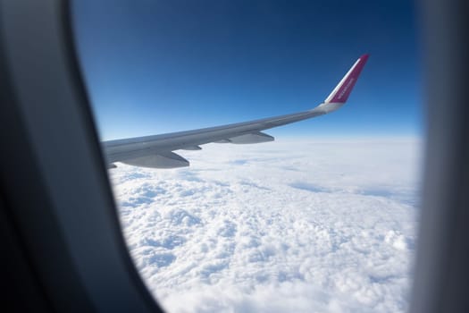 5 April 2023 Belgrade, Serbia: view from the airplane window on the wing of the aircraft - wizz air company. Mid shot