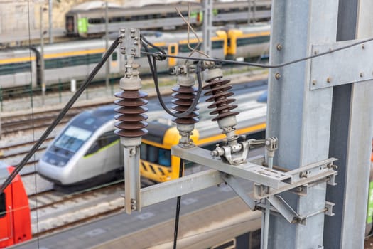 Electrical connections - Bullet trains stand on the rails at the railway depot on the background. Aerial view