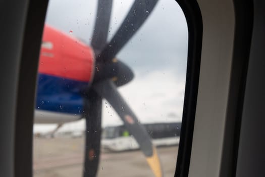 Propeller on the wing of an airplane - view from the window. Mid shot