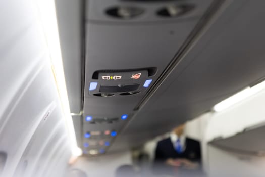 Burning No Smoking Sign and Fasten Seat Belt on Board Aircraft. Mid shot